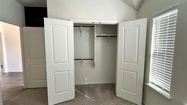 a bathroom with a double vanity sink a toilet and shower