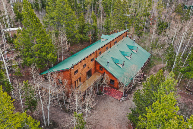 4725 Pine Ridge Road Evanston, UT 82930 - Photo 75 of 82 Rustic exterior featuring wood siding and a vibrant green metal roof with multiple dormers