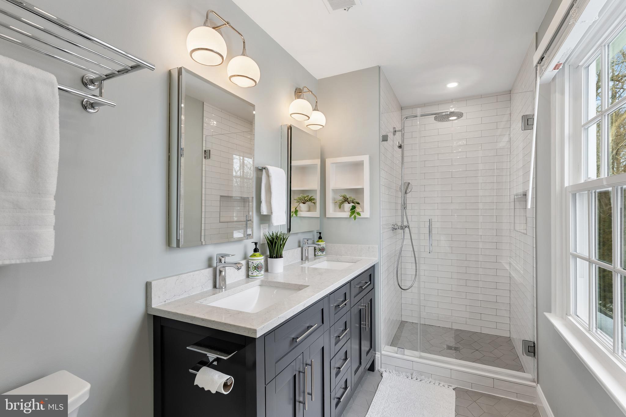 6443 Linway Terrace McLean, VA 22101 - Photo 23 of 53 a bathroom with a sink a mirror a vanity and a shower