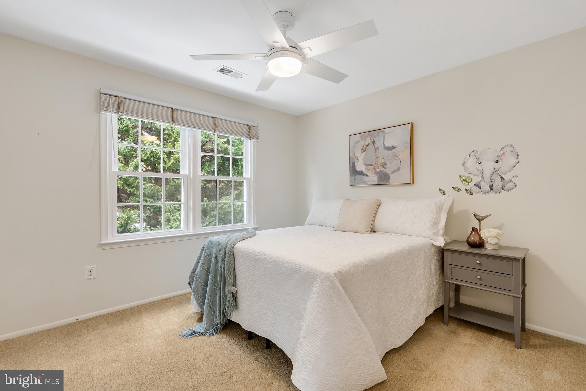 6443 Linway Terrace McLean, VA 22101 - Photo 29 of 53 a spacious bedroom with a bed and a chandelier