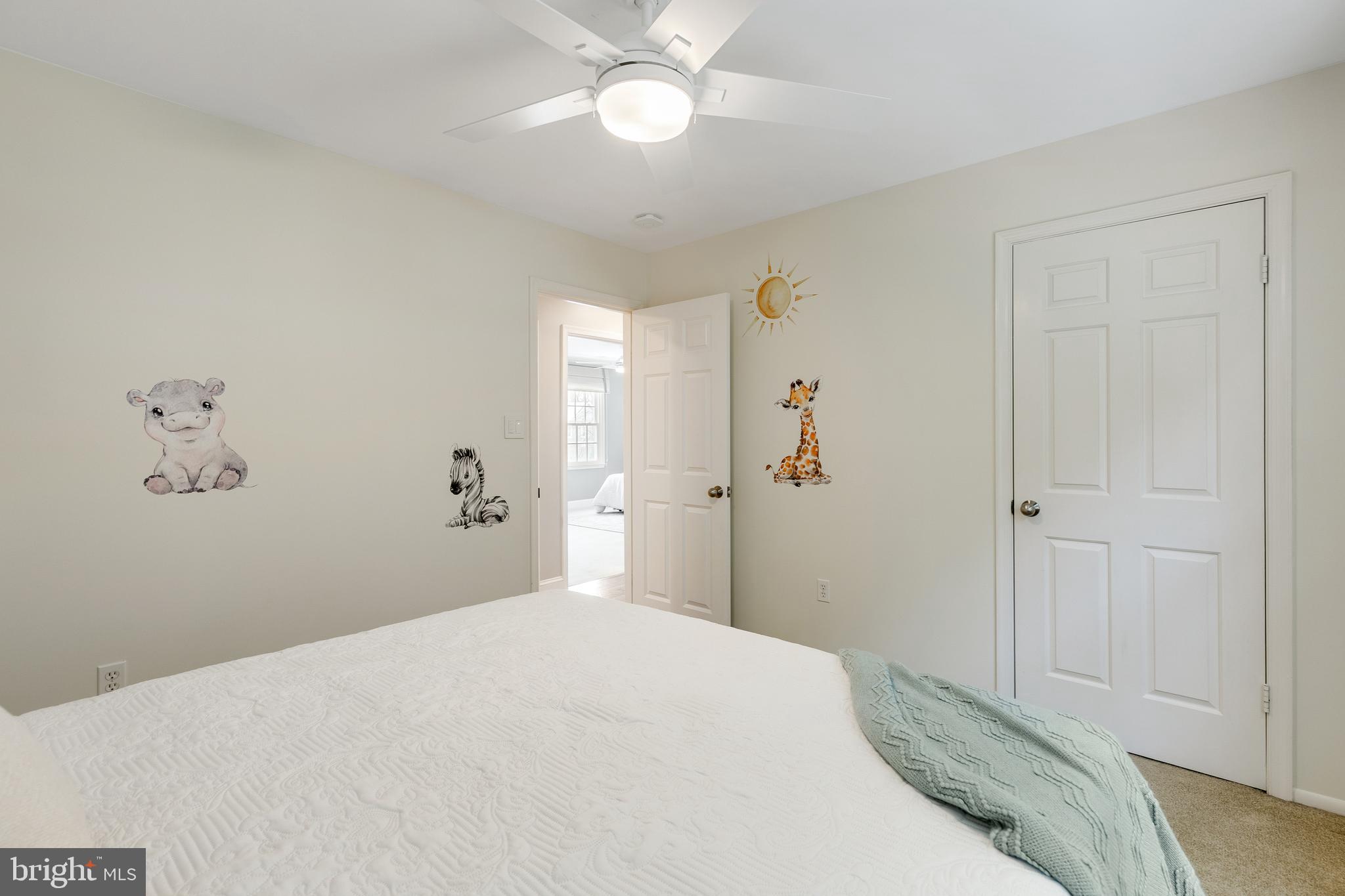 6443 Linway Terrace McLean, VA 22101 - Photo 30 of 53 a bedroom with a bed and a chandelier