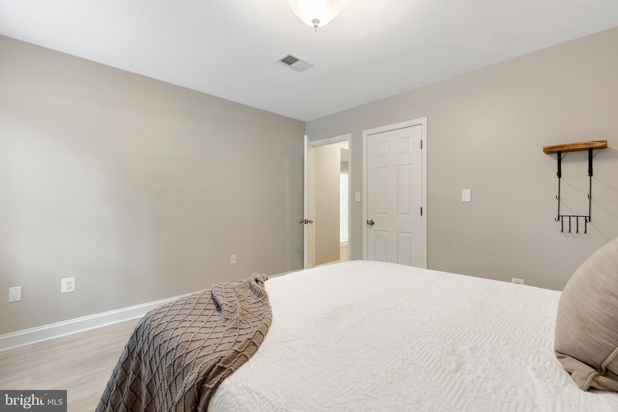 6443 Linway Terrace McLean, VA 22101 - Photo 34 of 53 a bedroom with a bed and a painting on the wall