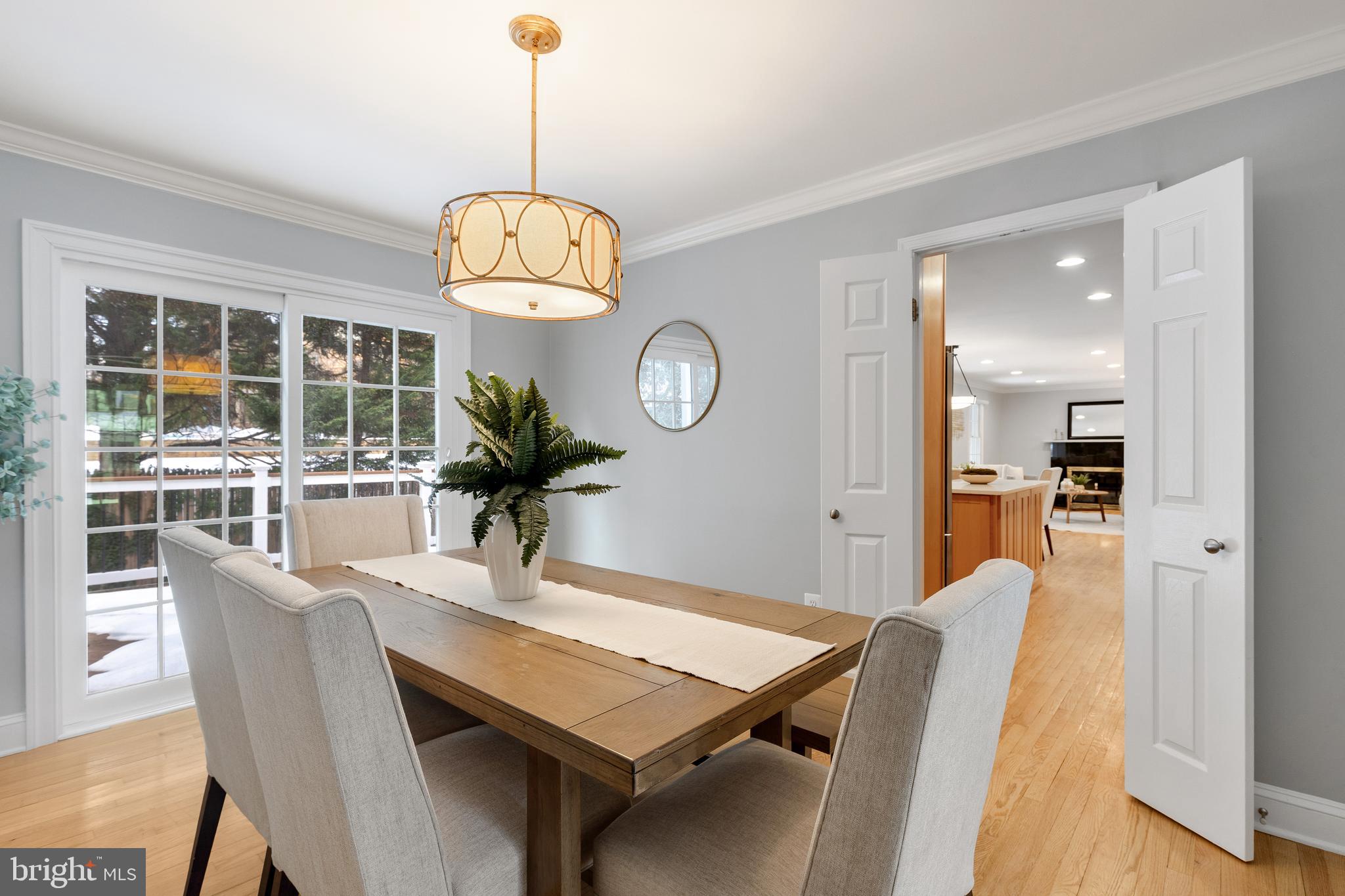6443 Linway Terrace McLean, VA 22101 - Photo 9 of 53 a dining room with wooden floor a chandelier a wooden table and chairs