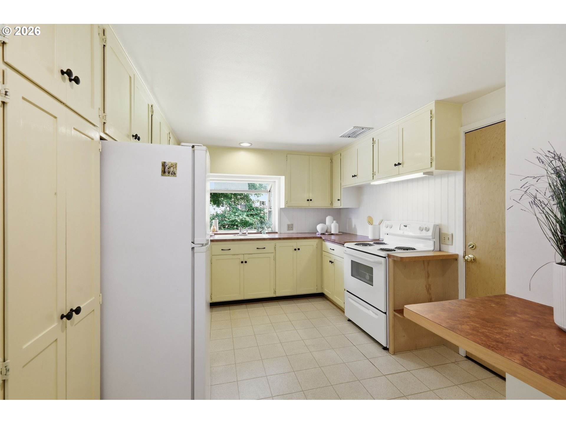 3025 Harris Street Eugene, OR 97405 - Photo 15 of 44 a kitchen with a stove a sink and a refrigerator
