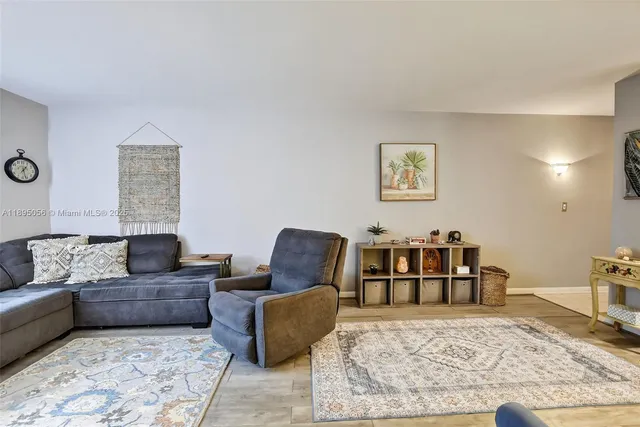 a living room with furniture rug and lamp