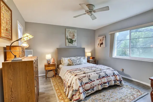 a bedroom with a bed dresser and a window