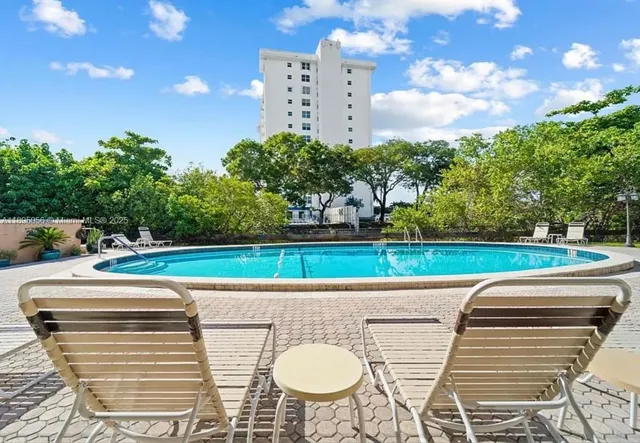 a view of a swimming pool with a patio