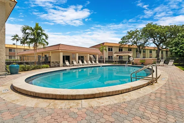 a view of an house with swimming pool and porch