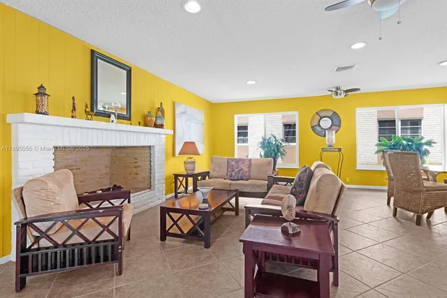 a living room with furniture a fireplace and a flat screen tv