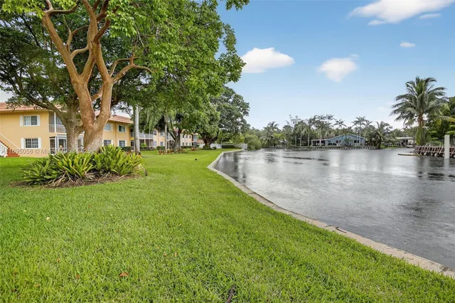 a view of a lake with houses in the back
