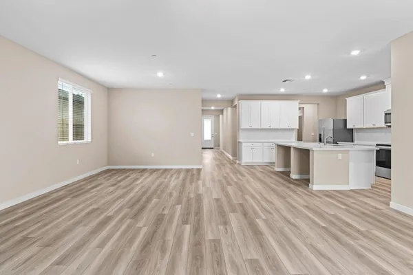 a view of kitchen with wooden floor and electronic appliances