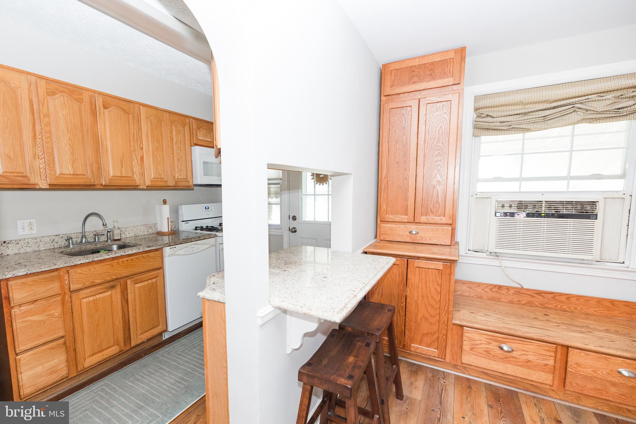 1083 Elm Road Baltimore, MD 21227 - Photo 13 of 33 a kitchen with stainless steel appliances granite countertop a stove a sink and a microwave