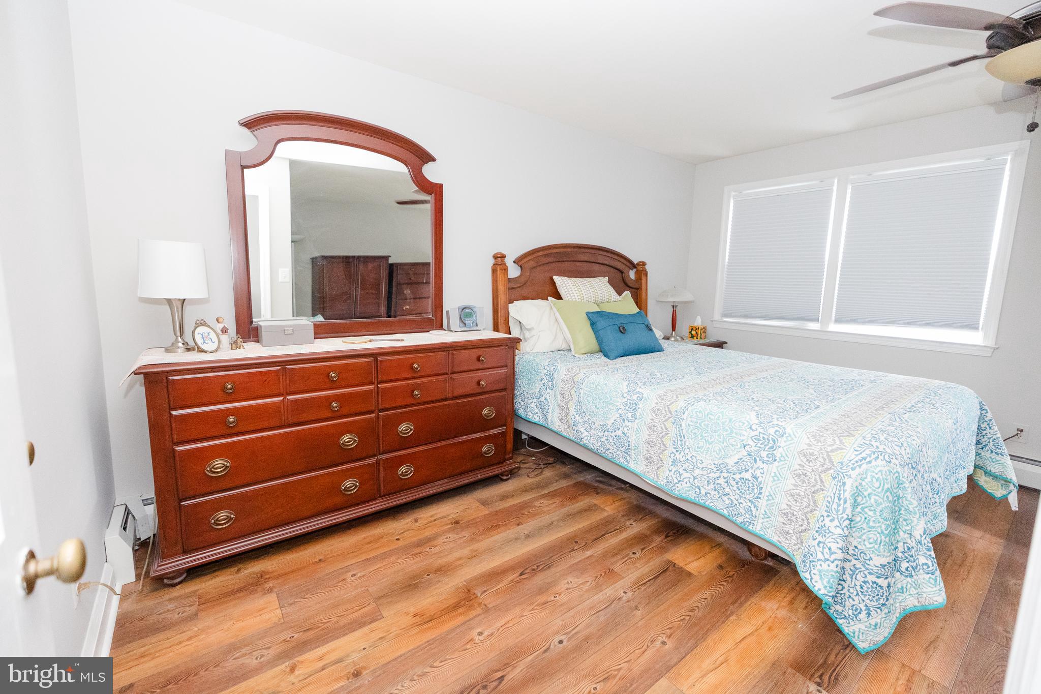 1083 Elm Road Baltimore, MD 21227 - Photo 16 of 33 a bedroom with a bed and a mirror on dresser
