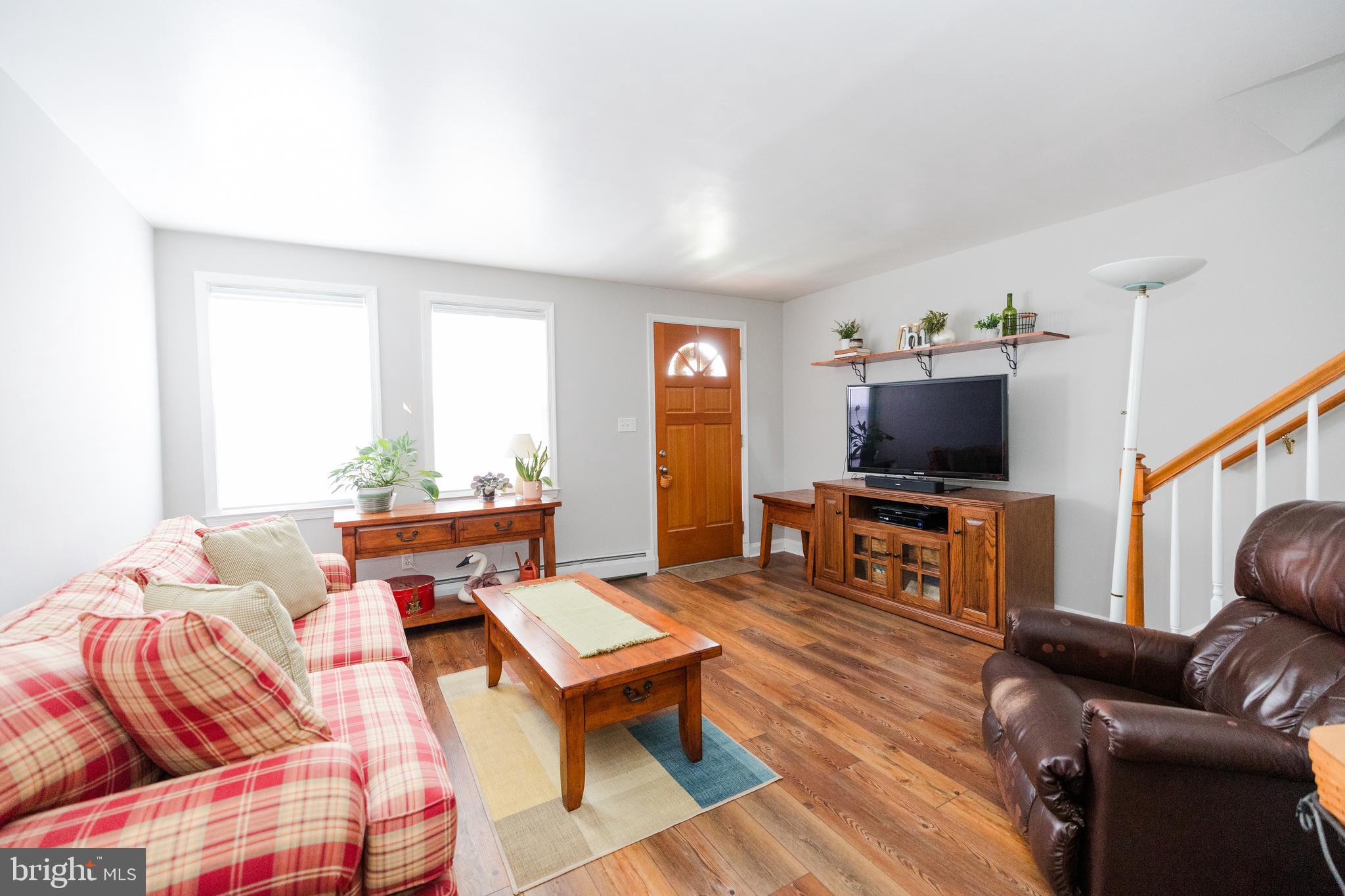 1083 Elm Road Baltimore, MD 21227 - Photo 6 of 33 a living room with furniture and a flat screen tv