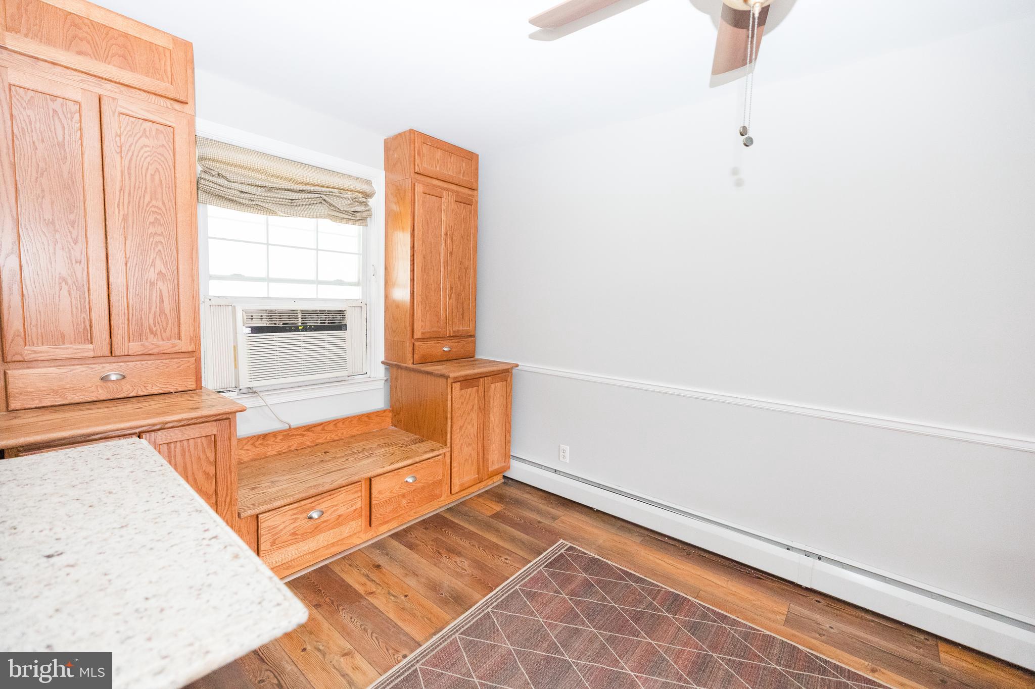 1083 Elm Road Baltimore, MD 21227 - Photo 9 of 33 a view of a room with rack on the wall and a window