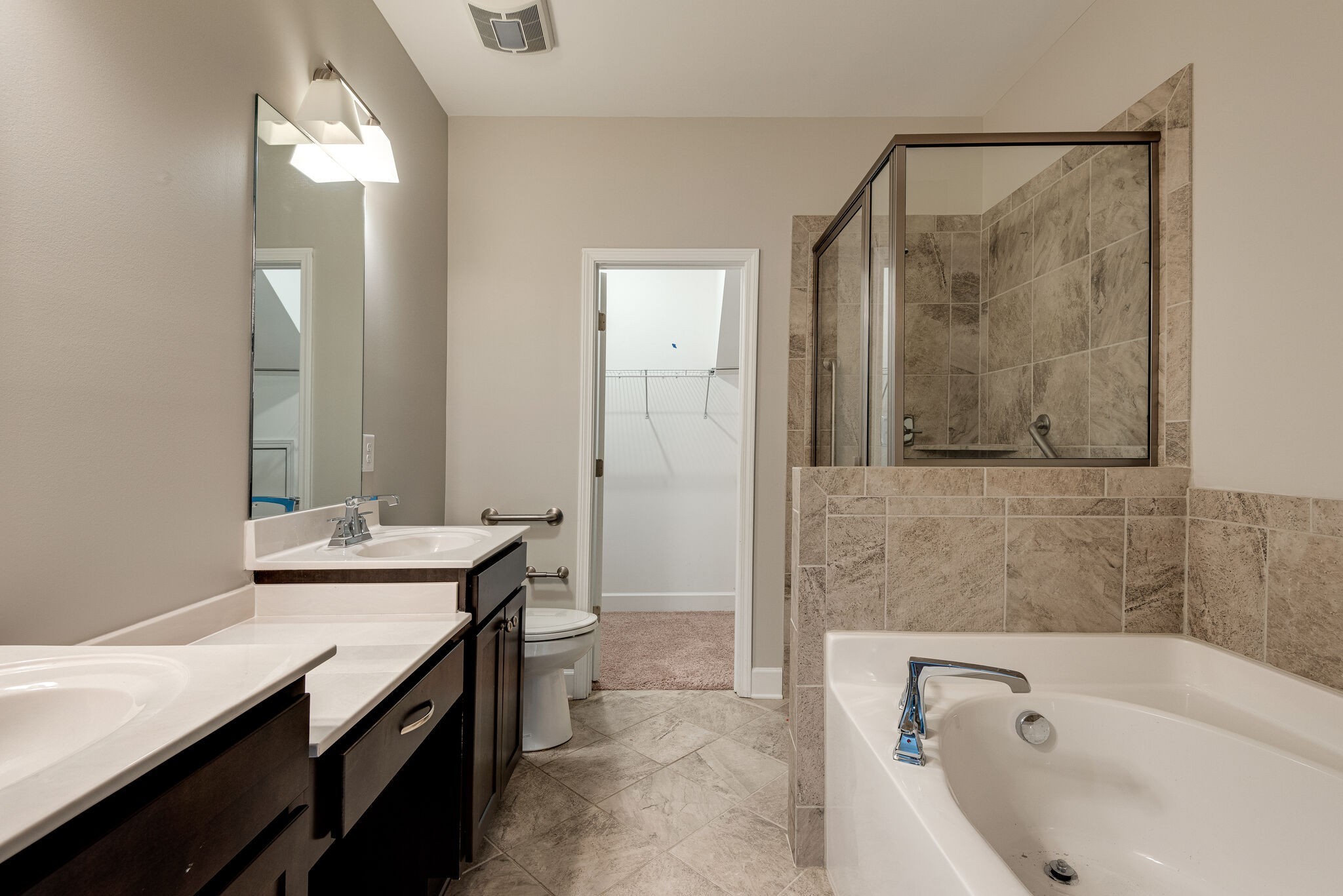 269 Mary Ann Circle Spring Hill, TN 37174 - Photo 15 of 28 a bathroom with a tub sink and mirror