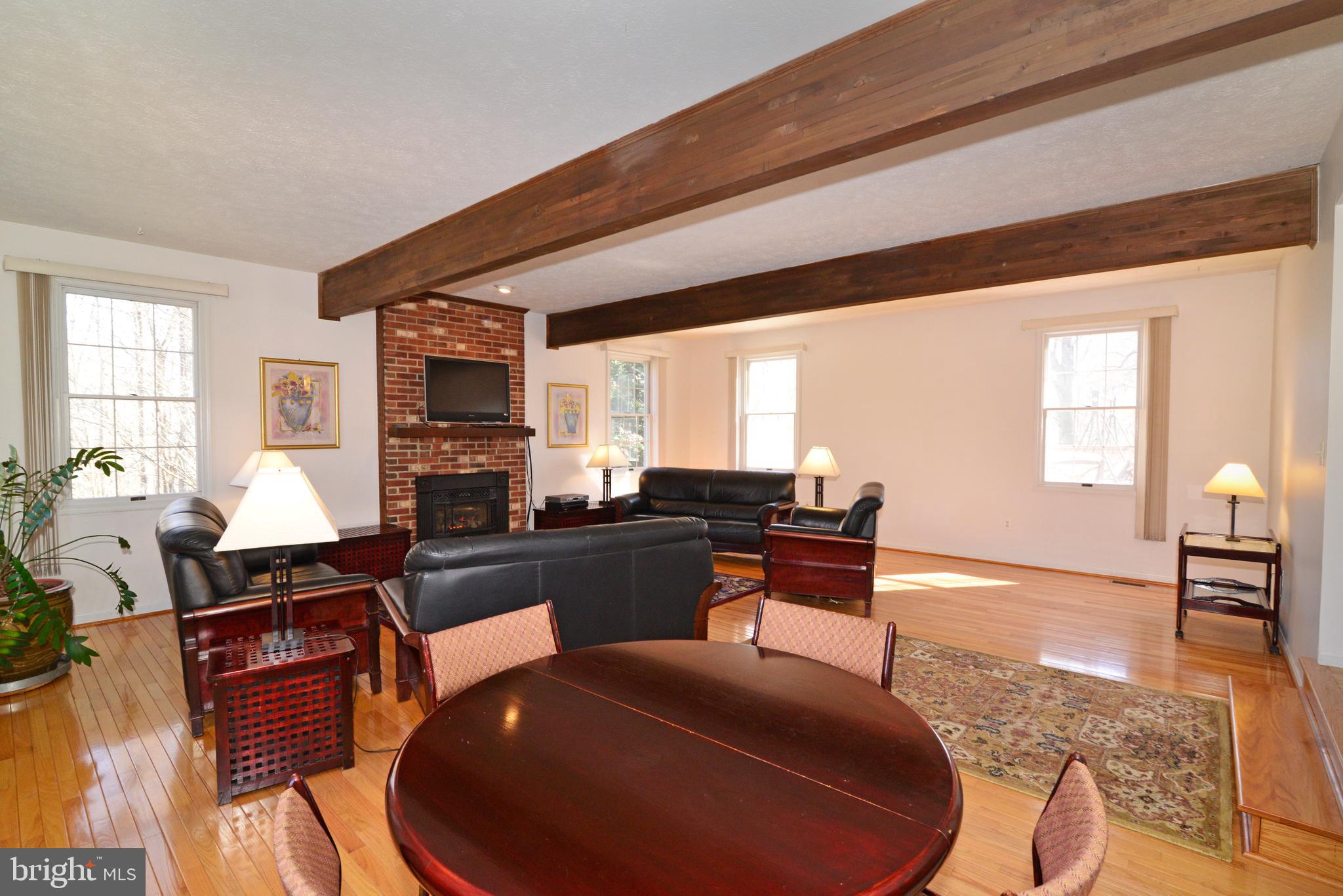 1966 Barton Hill Road Reston, VA 20191 - Photo 34 of 52 a living room with furniture a fireplace and a large window