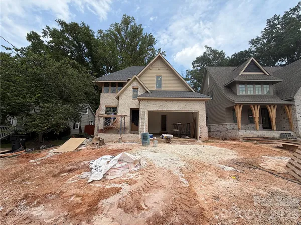 a view of a house with yard and sitting area