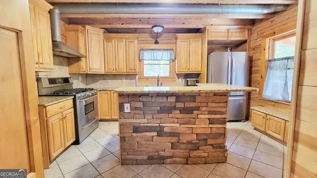 a kitchen with stainless steel appliances granite countertop a stove and a refrigerator