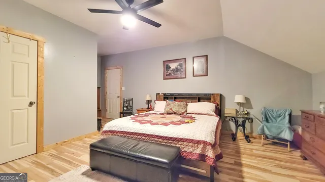 a bedroom with a bed and ceiling fan