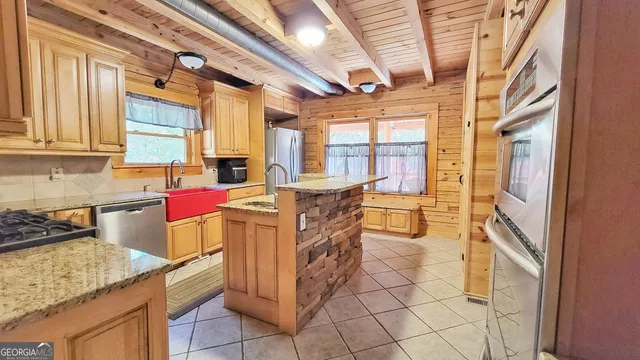 a kitchen with a sink a stove and cabinets