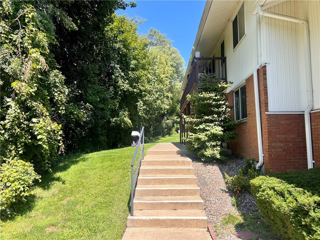 a park view with potted plants and large trees