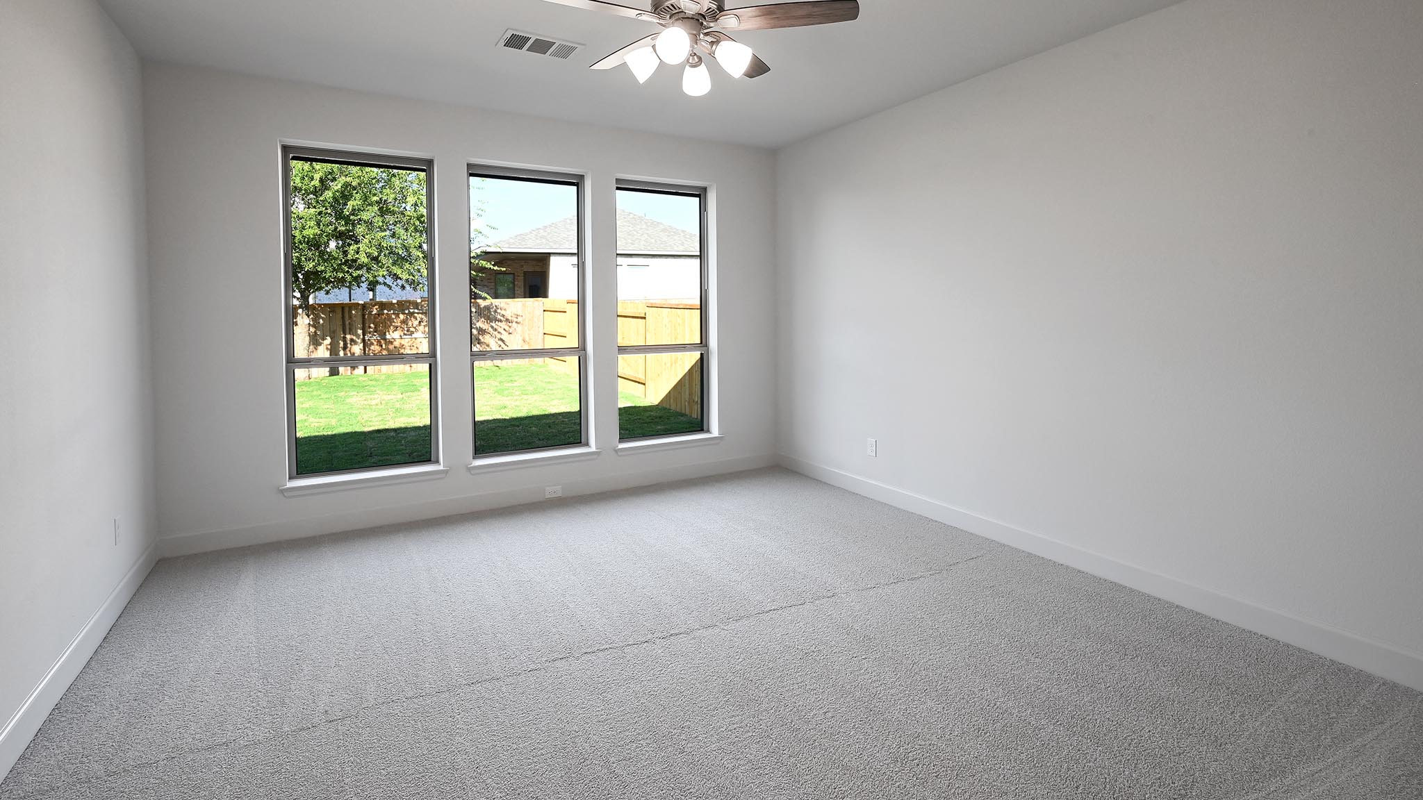 523 Prickly Poppy Loop Kyle, TX 78640 - Photo 10 of 40 an empty room with windows and chandelier fan
