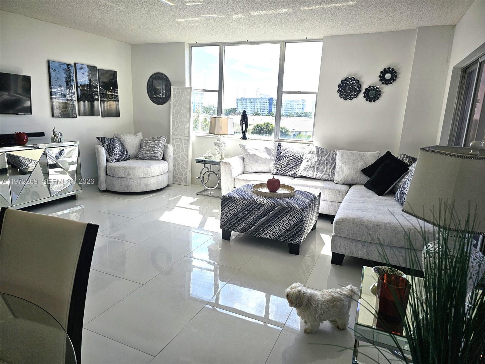3850 Washington Street, Unit 516 Hollywood, FL 33021 - Photo 1 of 17 a bedroom with furniture and a large window