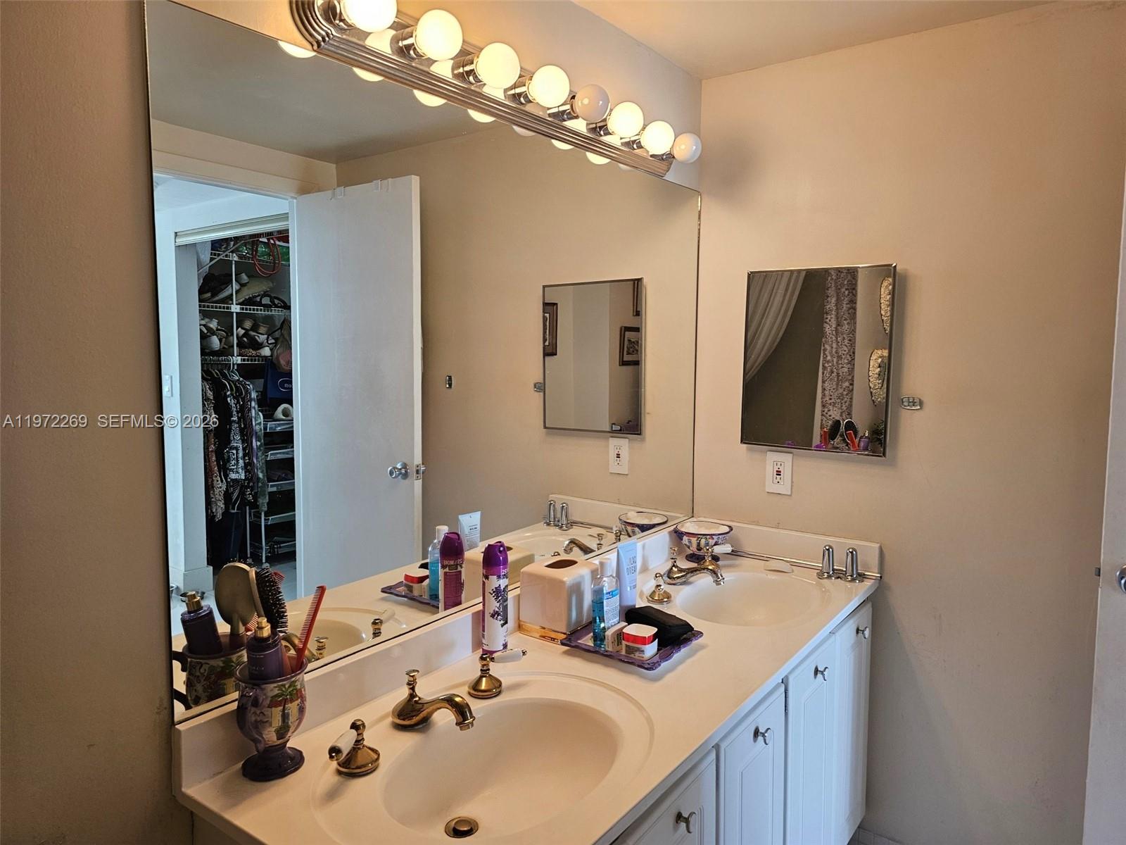 3850 Washington Street, Unit 516 Hollywood, FL 33021 - Photo 11 of 17 a bathroom with a sink double vanity and a mirror