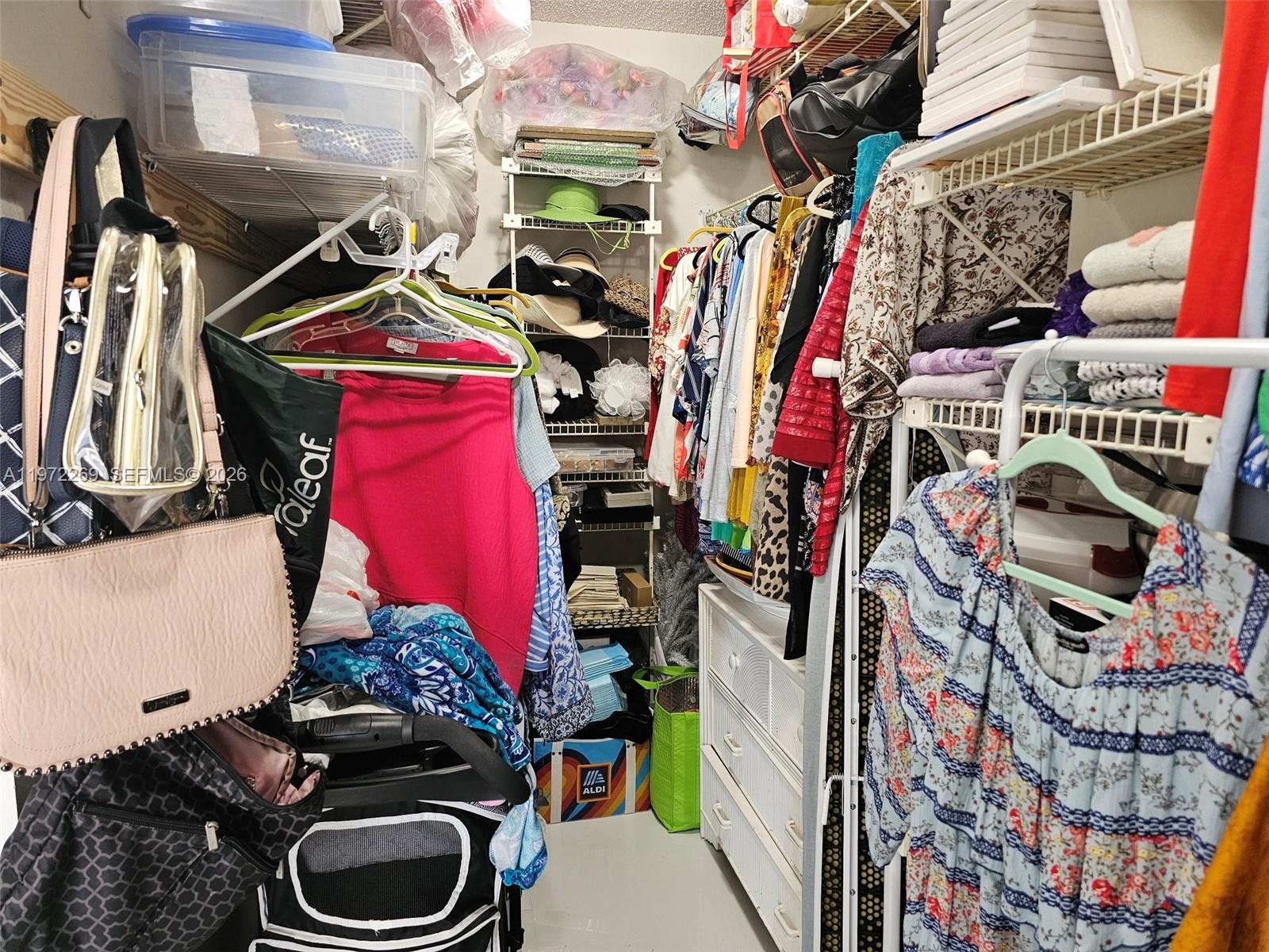 3850 Washington Street, Unit 516 Hollywood, FL 33021 - Photo 13 of 17 a view of walk in closet with clothes and shoes