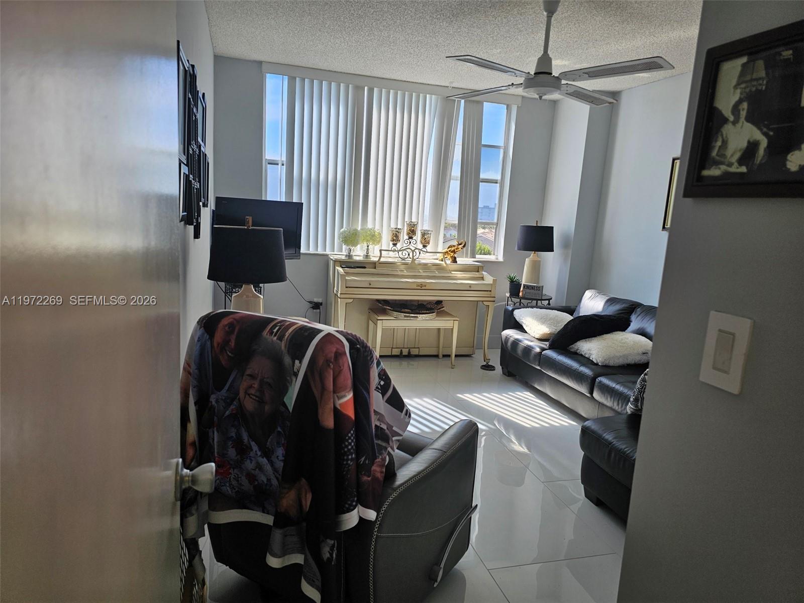 3850 Washington Street, Unit 516 Hollywood, FL 33021 - Photo 14 of 17 a living room with furniture a flat screen tv and a window