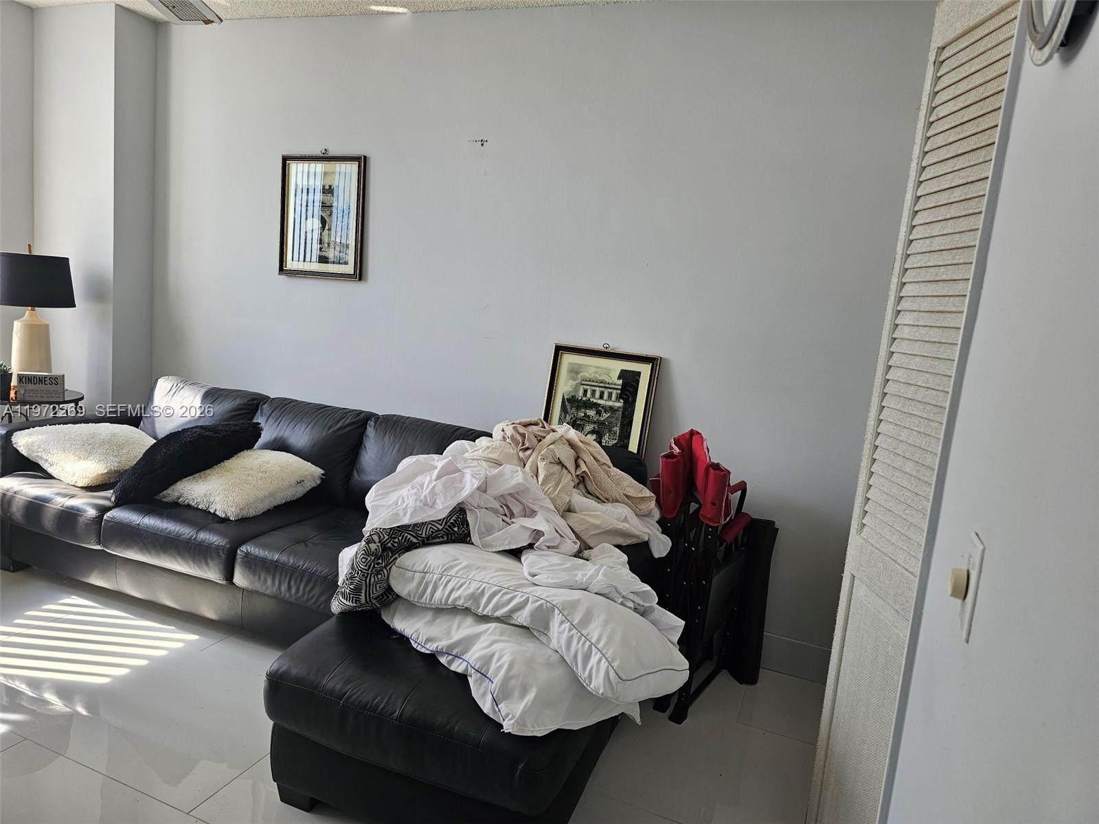 3850 Washington Street, Unit 516 Hollywood, FL 33021 - Photo 15 of 17 a living room with furniture and baby crib