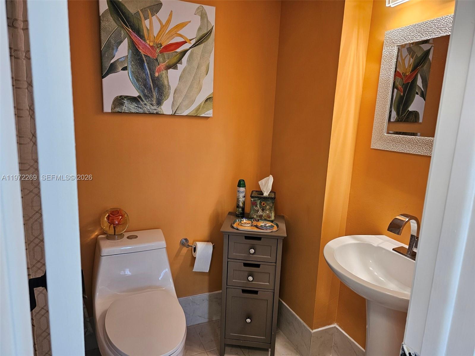 3850 Washington Street, Unit 516 Hollywood, FL 33021 - Photo 16 of 17 a bathroom with a toilet a sink and mirror