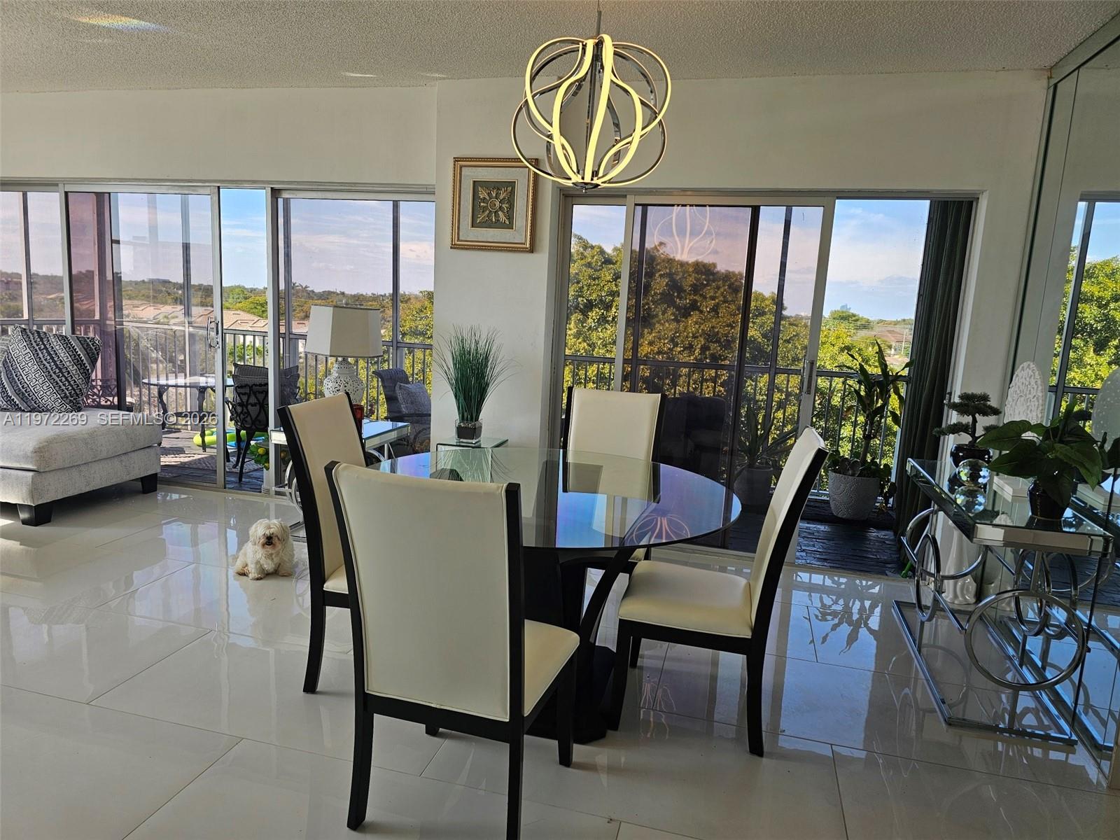 3850 Washington Street, Unit 516 Hollywood, FL 33021 - Photo 2 of 17 a view of a dining room with furniture window and wooden floor