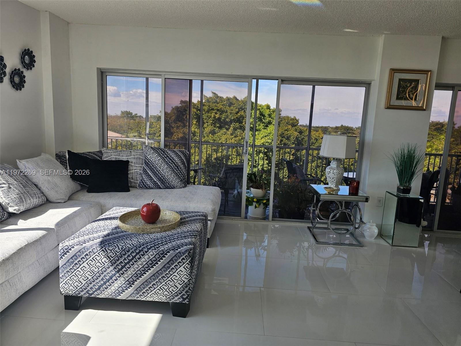 3850 Washington Street, Unit 516 Hollywood, FL 33021 - Photo 3 of 17 a living room with furniture and a potted plant