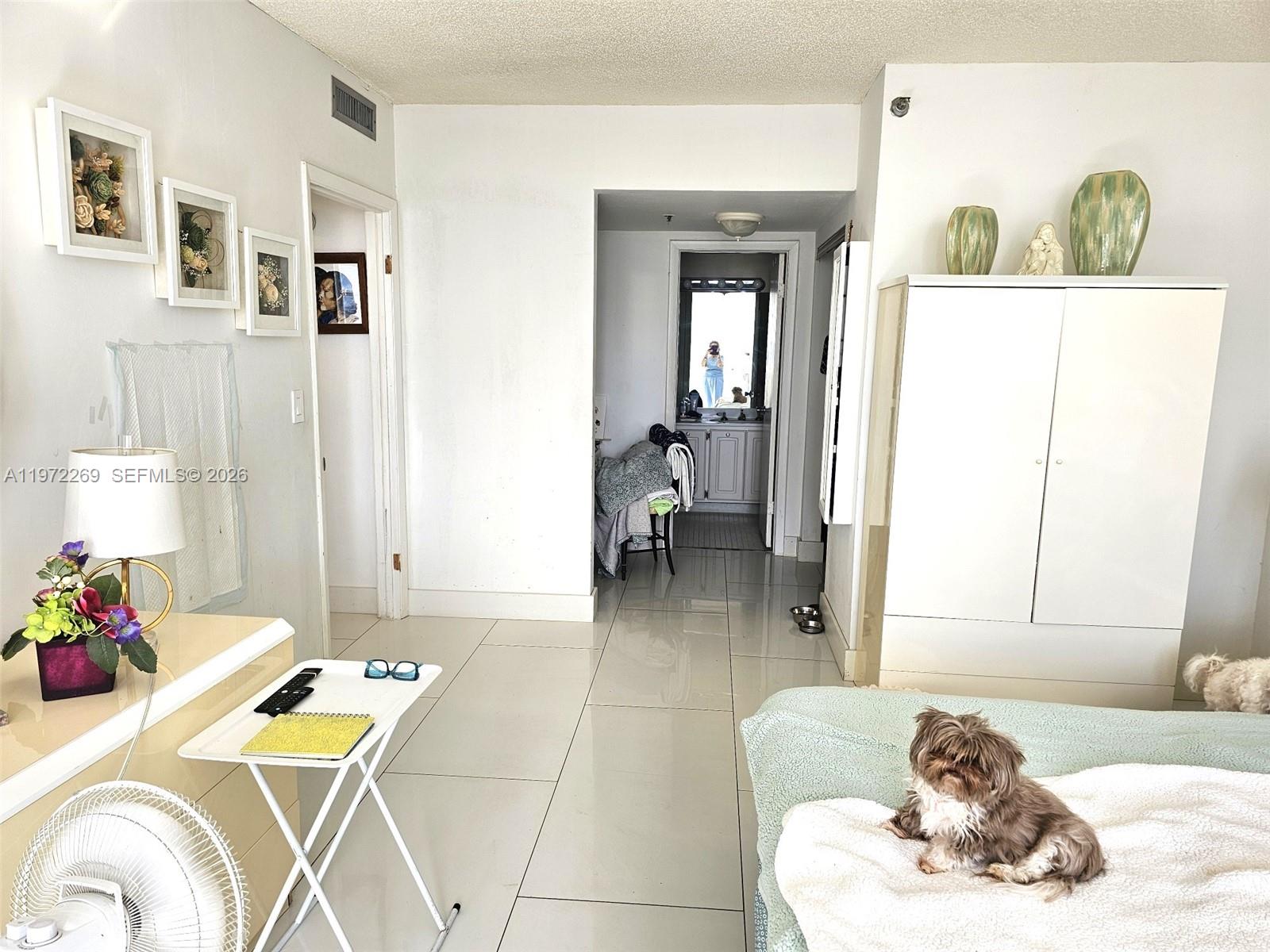 3850 Washington Street, Unit 516 Hollywood, FL 33021 - Photo 8 of 17 a bedroom with a bed and wooden floor