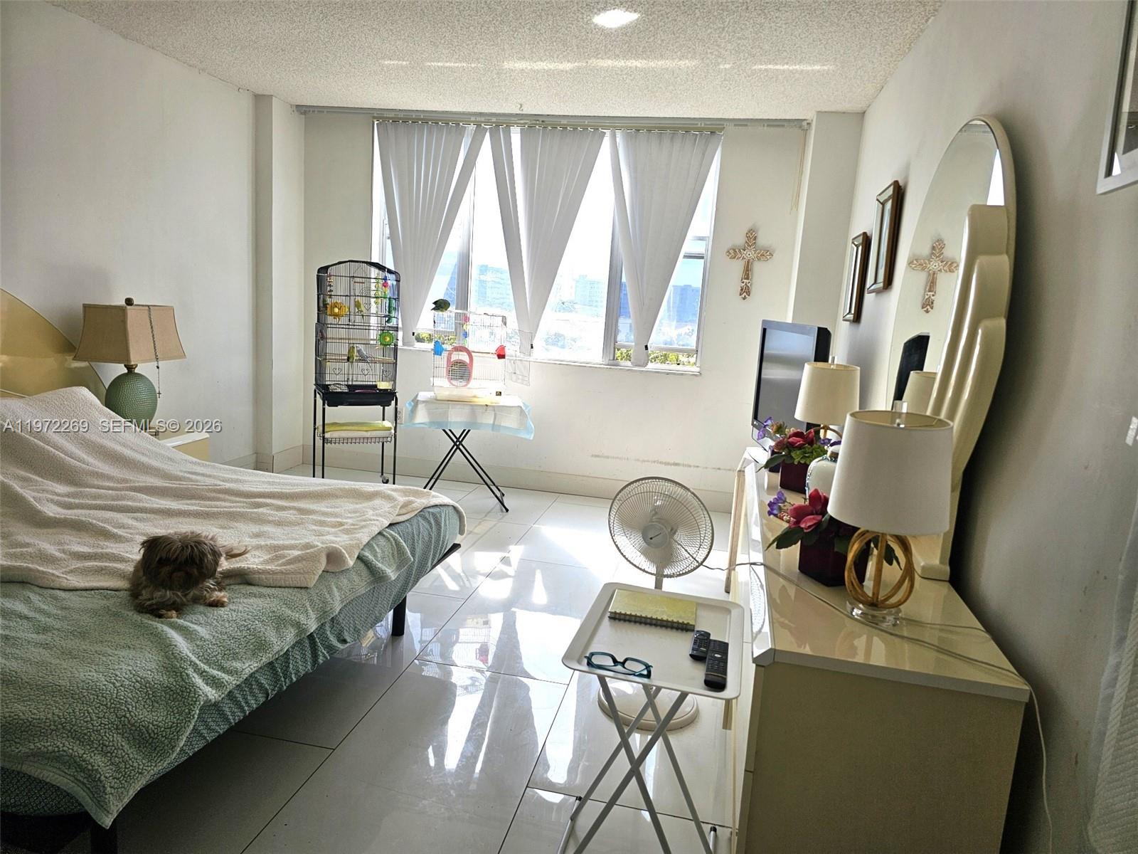 3850 Washington Street, Unit 516 Hollywood, FL 33021 - Photo 9 of 17 a bedroom with a bed and large windows