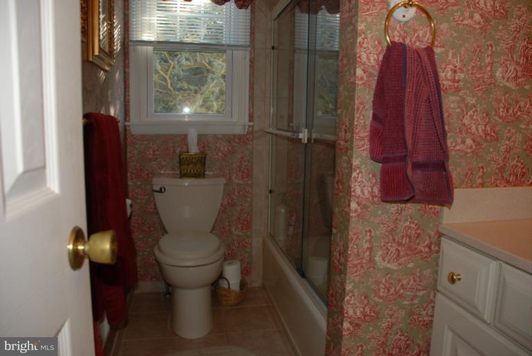 2302 Furnace Road Fallston, MD 21047 - Photo 11 of 23 a bathroom with a toilet and a shower curtain