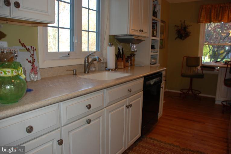 2302 Furnace Road Fallston, MD 21047 - Photo 20 of 23 a kitchen with stainless steel appliances white cabinets a sink a window and wooden floor