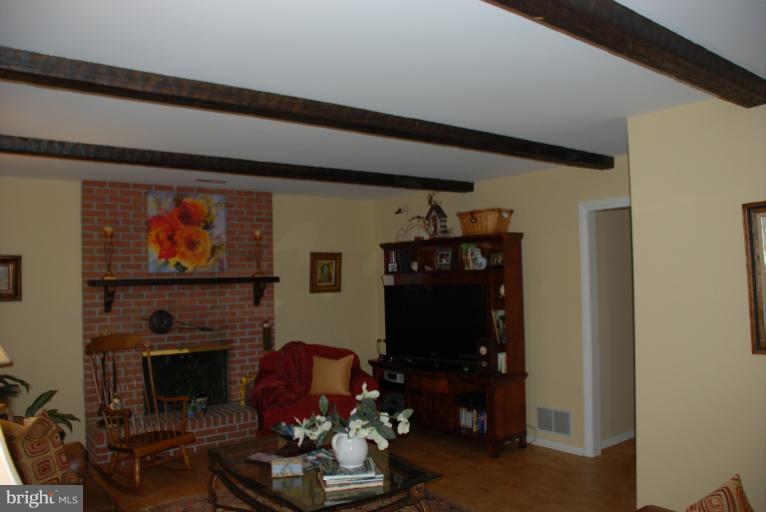2302 Furnace Road Fallston, MD 21047 - Photo 7 of 23 a living room with furniture a fireplace and a flat screen tv