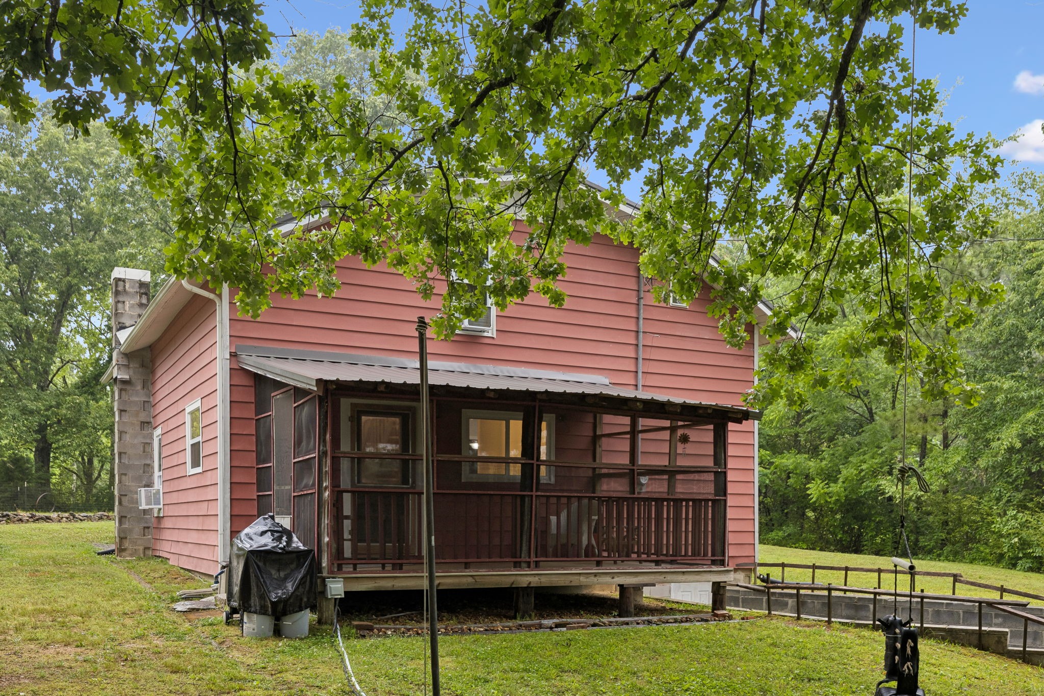 121 Hannah Road Summertown, TN 38483 - Photo 41 of 52 a backyard of a house with barbeque oven and table