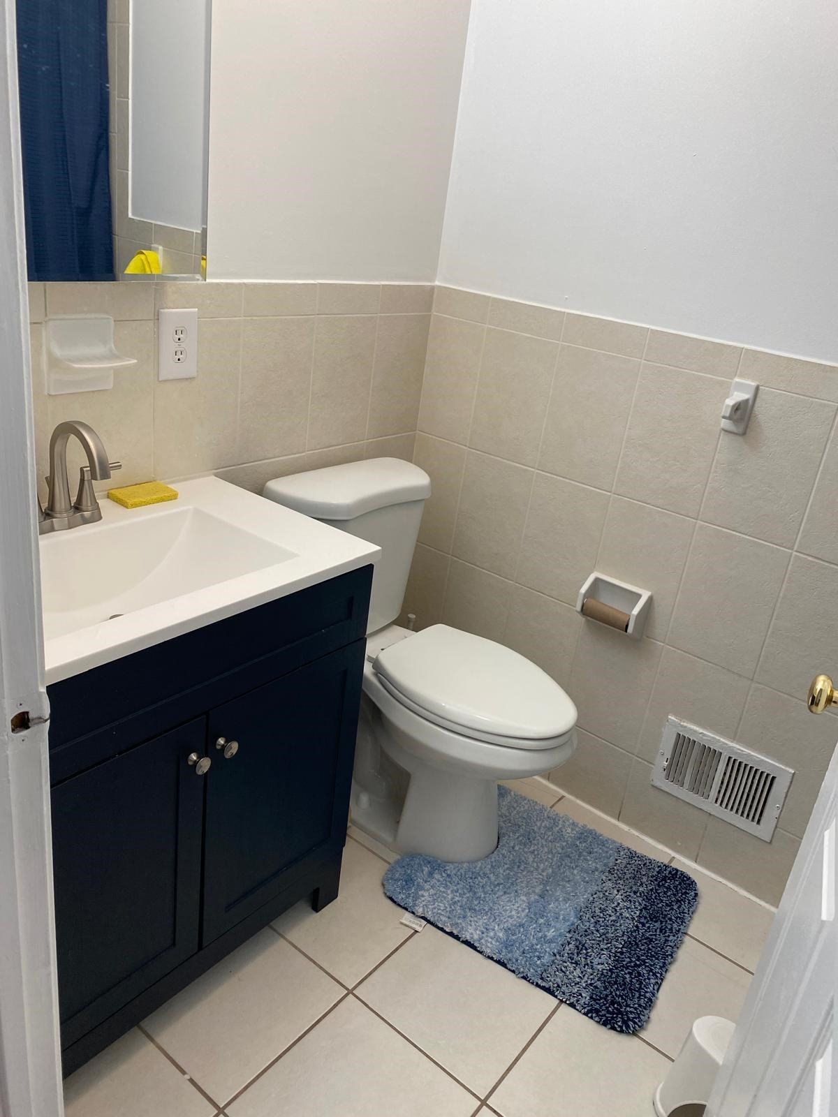225 Belvidere Avenue, Unit 2 Jersey City, NJ 07306 - Photo 7 of 18 a bathroom with a sink a toilet and a mirror