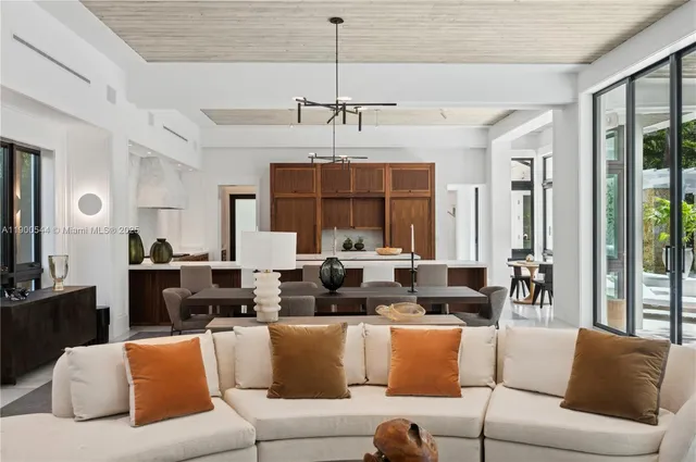 a living room with stainless steel appliances granite countertop a stove a sink and a granite counter tops with white cabinets