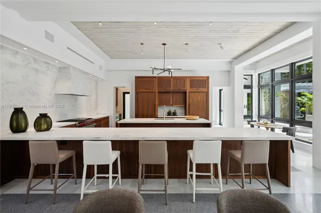 a living room with furniture and floor to ceiling window