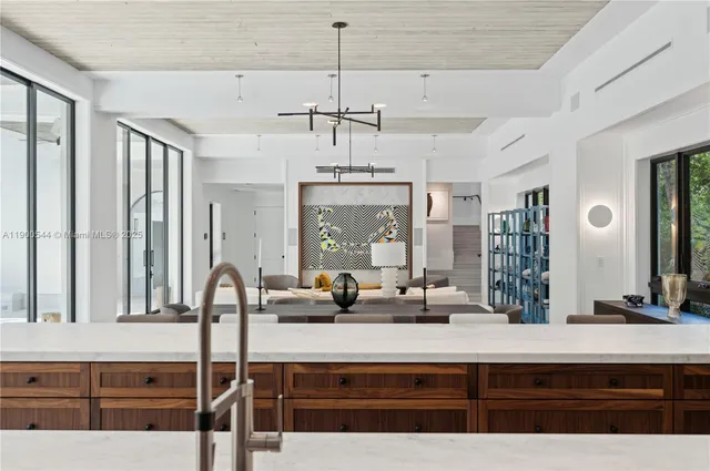 a view of a dining room with furniture large windows and wooden floor