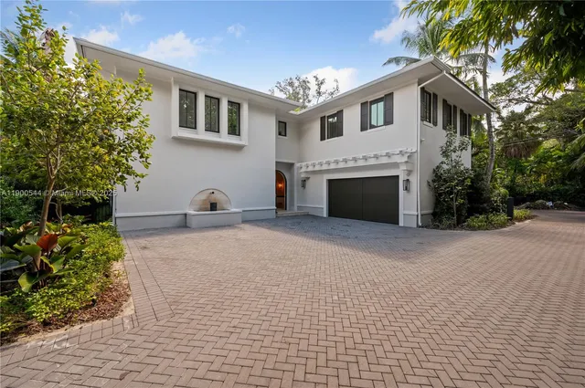 a living room with furniture a fireplace and a floor to ceiling window
