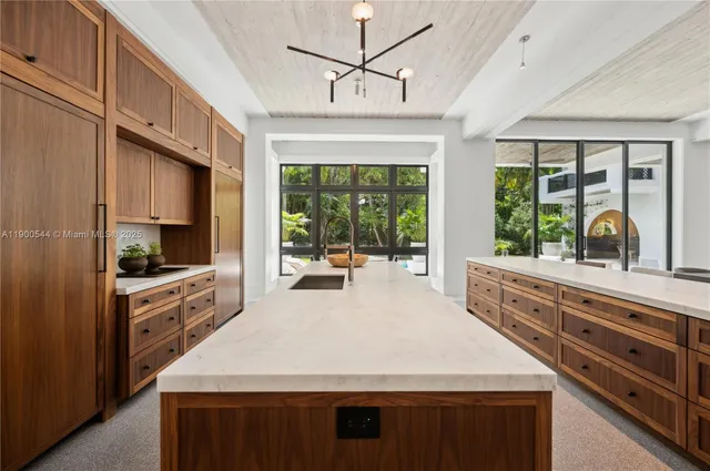 a bedroom with a bed painting on wall and a large window