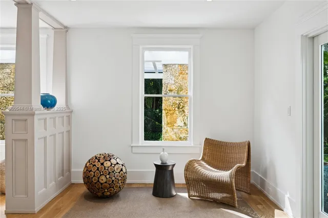 a living room with furniture a window and a chandelier