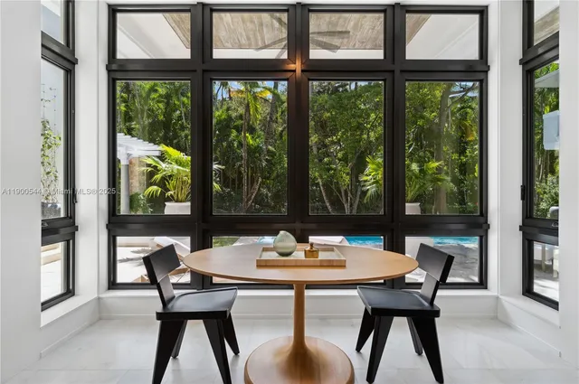 a living room with furniture and large windows