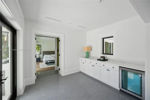 a living room with a large window and furniture